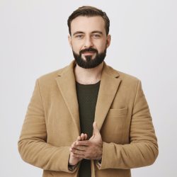 Confident handsome businessman rubbing his hands over white background. Satisfied man already knows that deal with another company will be signed so he feels happy, enjoying this moment Confident handsome businessman rubbing his hands over white background. Satisfied man already knows that deal with another company will be signed so he feels happy, enjoying this moment.